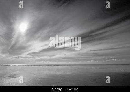 An empty beach at Littlehampton, West Sussex as the sun broke through the clouds at low tide Stock Photo