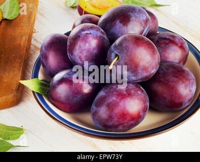 Plums on a  wooden table.  Selective focus Stock Photo