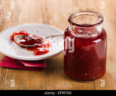 Strawberry jam on  wooden background. Selective focus Stock Photo
