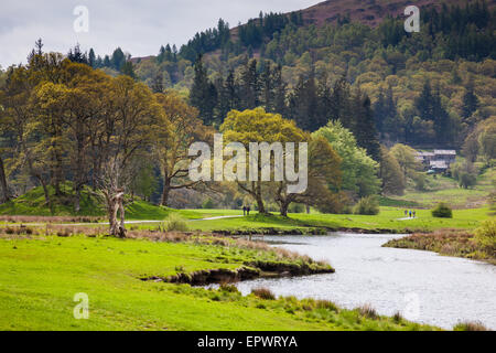 Walkers on the footpath alongside the River Brathay, near Elterwater, Lake District, Cumbria Stock Photo