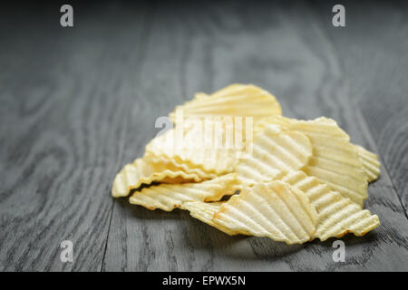 rippled organic chips on wooden table Stock Photo