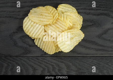 rippled organic chips on wooden table Stock Photo