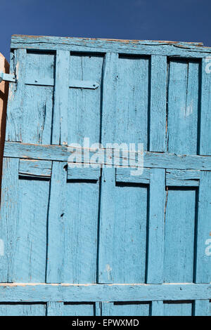 An old weathered pueblo blue door, Taos, New Mexico, USA. Stock Photo