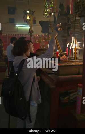 dh Man Mo Temple SHEUNG WAN HONG KONG Chinese woman joss sticks temple praying china toaist joss stick people