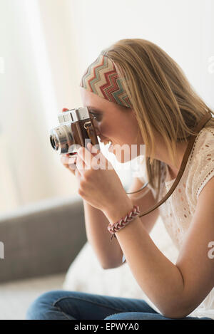 Woman using antique camera Stock Photo