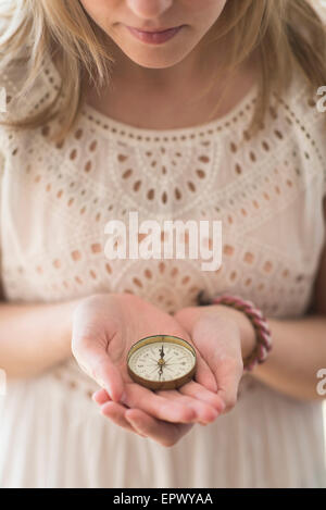 Woman holding navigation compass Stock Photo