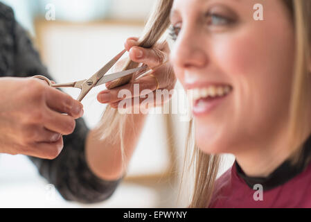 Woman getting haircut Stock Photo