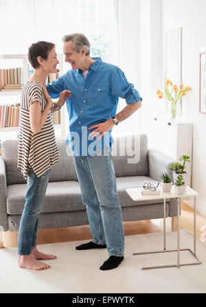 Senior couple talking in living room Stock Photo