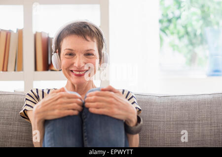 Portrait of smiling senior woman with headphones Stock Photo