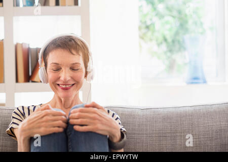 Smiling senior woman with headphones Stock Photo