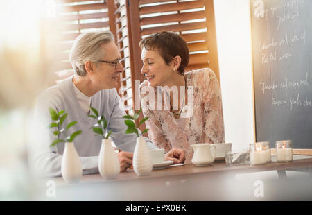Senior couple sitting in restaurant Stock Photo