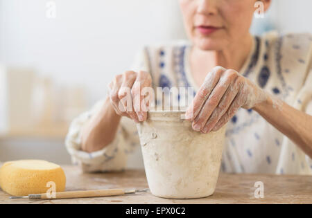Senior woman making flower pot at workshop Stock Photo