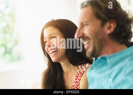 Couple laughing on sofa Stock Photo