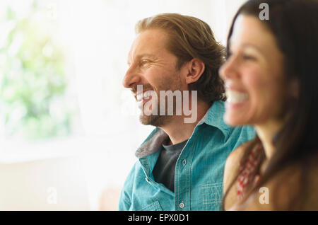 Couple laughing on sofa Stock Photo