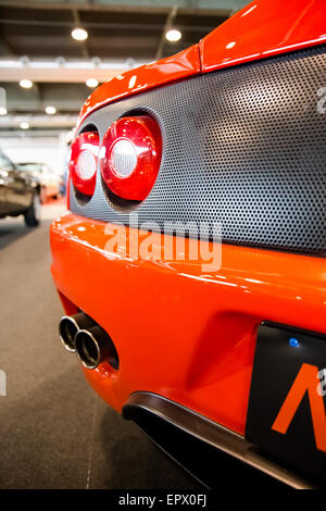 exhaust pipes and tail lights of a bright orange sports car Stock Photo