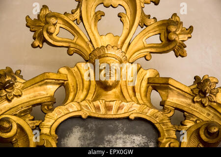 detail of a carved gilded frame of an antique mirror Stock Photo
