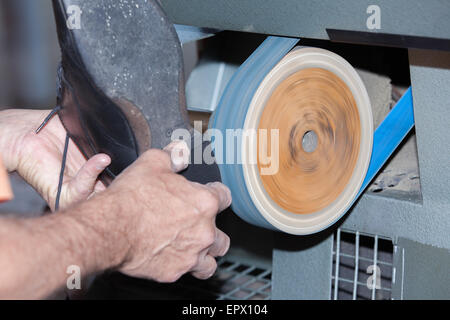 the shoemaker repairs a shoe Stock Photo