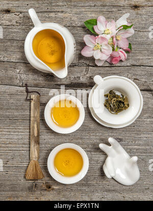 Teapot and cups on rustic wooden table. Utensils for traditional chinese tea ceremony Stock Photo