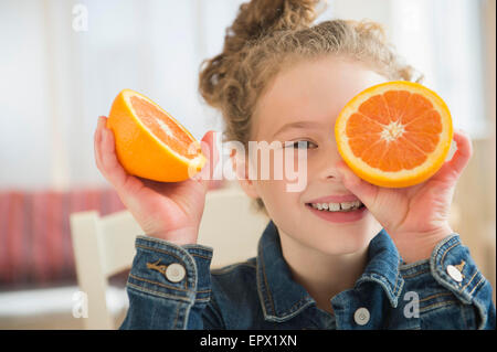 Girl (10-11) holding orange Stock Photo