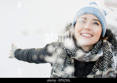 Portrait of smiling woman in snow Stock Photo