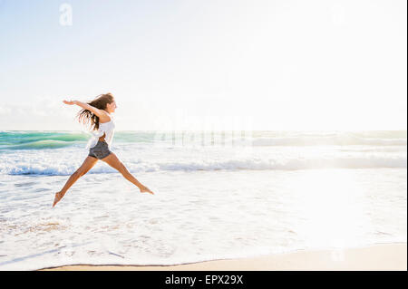 USA, Florida, Jupiter, Woman jumping on beach Stock Photo