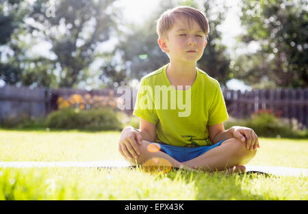 USA, Colorado, Boy (6-7) sitting in grass Stock Photo