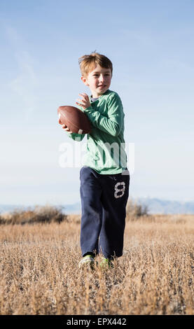 USA, Colorado, Boy (6-7) playing football Stock Photo