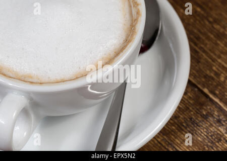 Close up cup of coffee on the wooden table Stock Photo