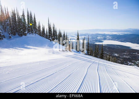 USA, Montana, Whitefish, Snowboarder on side of ski slope Stock Photo