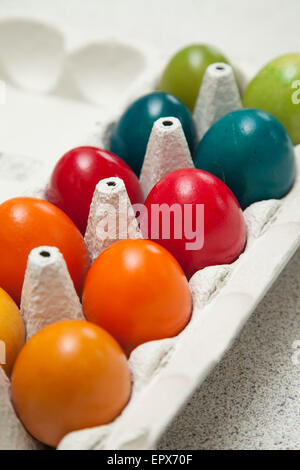 Ten eggs in an egg box which have been dyed for easter. Stock Photo