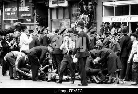 The Beatles in Liverpool, Friday 10th July 1964.  Back home for evening premiere of 'A Hard Day's Night' at the Odeon Cinema. Pictured, fans feeling faint outside Town Hall. Stock Photo