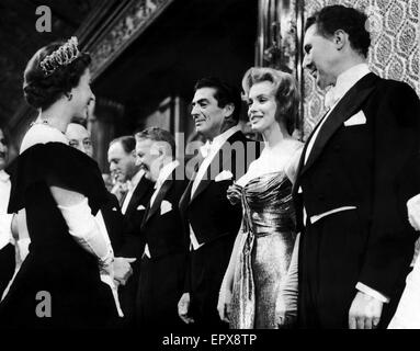 American film actress Marilyn Monroe meets Queen Elizabeth II at the Royal Command Film Performance at Leicester Square in London. 29th October 1956. Stock Photo