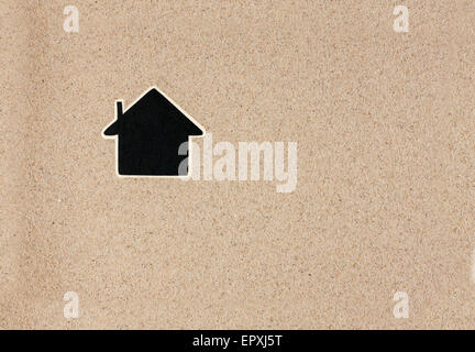 Pointer, ads board in the form house  in the sand, can be used as background Stock Photo