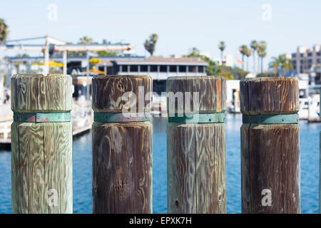 Wooden support posts on a shoreline boardwalk in Redondo Beach California during a bright, sunny day Stock Photo