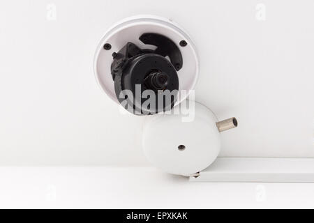 the surveillance camera strengthened on a ceiling indoors Stock Photo