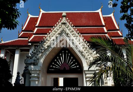 Bangkok, Thailand:  Entrance gate with lotus bud decorations and Ubosot sanctuary hall at Wat Pathum Wanaram Stock Photo