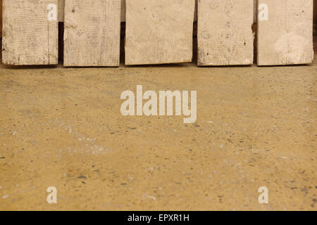 concrete floor on which there are vertically old boards Stock Photo