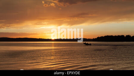 Boat in a bay at sunset, Georgian Bay, Tobermory, Ontario, Canada Stock Photo