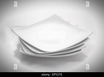 stack of square plates isolated on a white background Stock Photo - Alamy