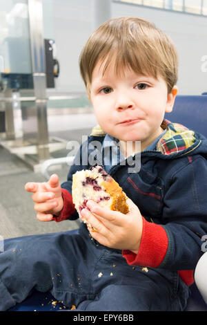 Portrait of a boy eating sweet bun Stock Photo