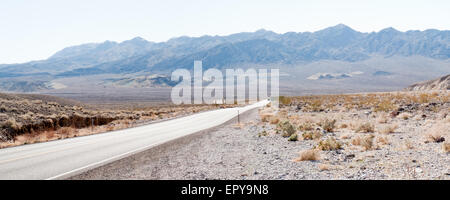 Straight road passing through landscape, Death Valley National Park, California, USA Stock Photo