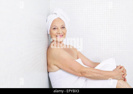 Elderly woman sitting releaxed in a relaxation room in spa Stock Photo