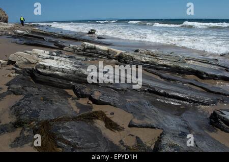 Los Angeles, USA. 22nd May, 2015. A policeman patrols a oil-covered beach in California, the United States, on May 22, 2015. The clean-up of oil spill in Santa Barbara County of Southern California continued on Friday. Credit:  Yang Lei/Xinhua/Alamy Live News Stock Photo