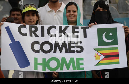 Lahore, Pakistan. 22nd May, 2015. Pakistani cricket lovers cheer their team as they attend the first International T20 cricket match between Pakistan and Zimbabwe carrying Pakistani flags and waited for hours before entering the Qaddafi Stadium. State-run PTV Sports reported about 30,000 spectators were inside the stadium to watch the contest. Credit:  Rana Sajid Hussain/Pacific Press/Alamy Live News Stock Photo