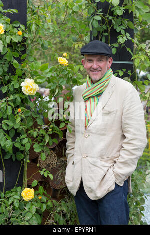 London, UK. 23 May 2015. Pictured: Sean Murray, the winner of the RHS Great Chelsea Garden Challenge in the garden he designed. The 2015 RHS Chelsea Flower Show draws to a close with the traditional sell-off of flowers from 4pm onwards. Credit:  Nick Savage/Alamy Live News Stock Photo