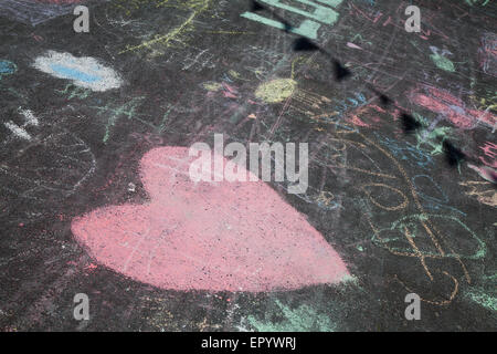 Southport, Merseyside, UK 23rd May, 2015. Children's chalk drawings as Arts & Crafts demos are staged in theTown Gardens, Wesley Street and unlet shopping units and arcades in Southport as a Bank Holiday tourist attraction.   A charity event organised by Macmillian Cancer Support. Credit:  Mar Photographics/Alamy Live News Stock Photo