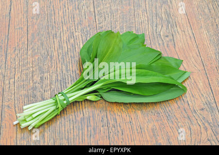 Wild garlic leaves on a wooden table Stock Photo