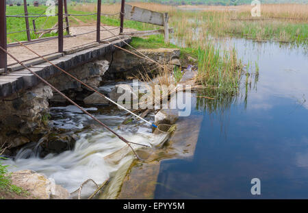 Weir on small river Kilchen and fishing technique in fast water in Ukraine Stock Photo