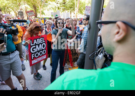 Saturday, May 23, 2015, Washington, DC USA:  Hundreds of food safety activists marched from the White House to Monsanto's  Washington office chanting and protesting against GMOs and pesticides, as part of an international revolt against Monsanto.  Monsanto employees responded by holding  up signs and talking with the press. Stock Photo