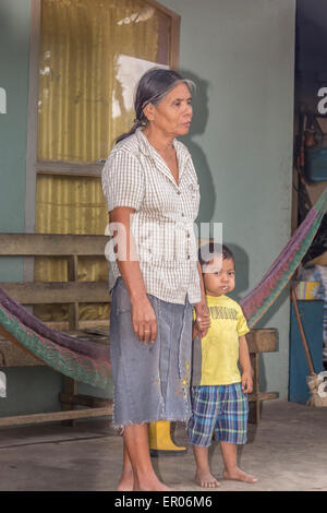 Mother and child standing on the front porch of their home in Guatemala